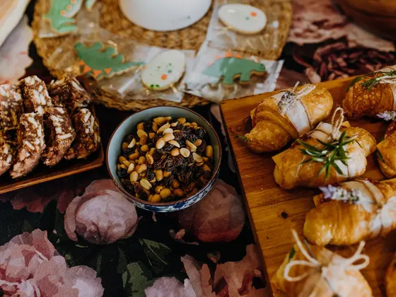 A grazing board of cured meats, nuts and pastries