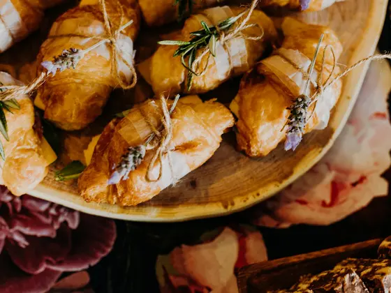 A wooden platter of assorted pastries